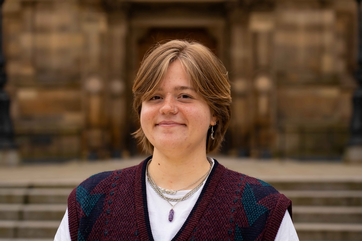 Portrait photo of Ash Scholz in front of McEwan Hall.