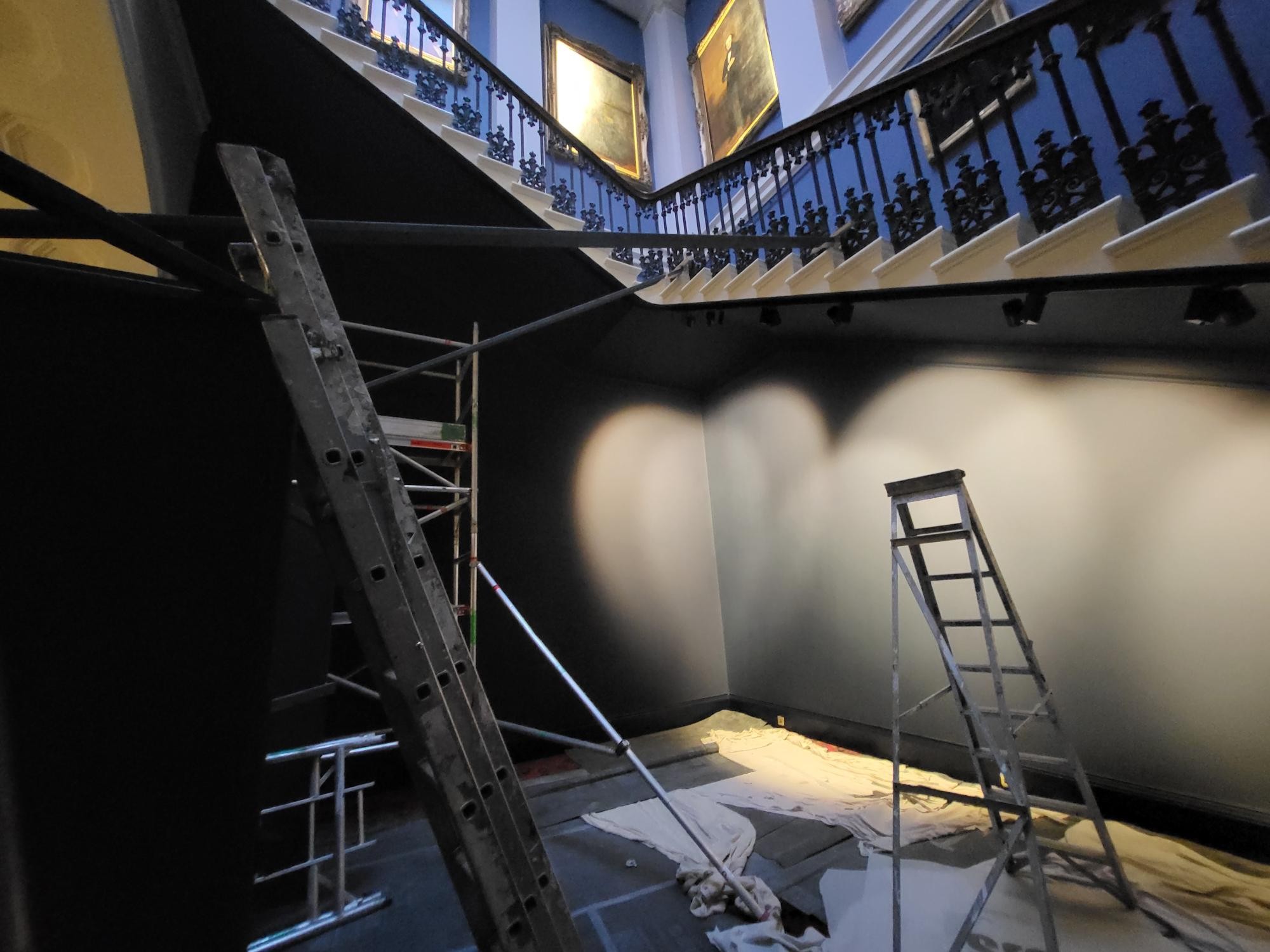 The main old college stairwell before the install. There are ladders in the photo.
