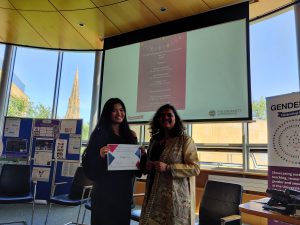 Maggie Lin receiving the award from Hemangini Gupta