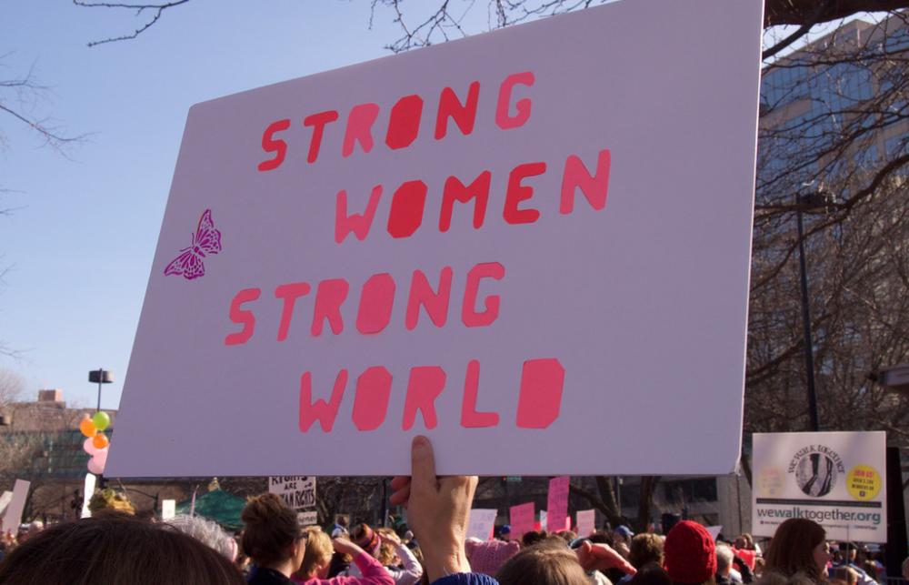 A sign reads Strong Women Strong World